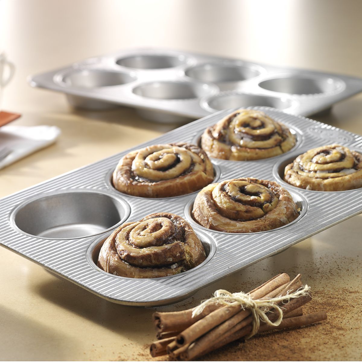 USA Pan mini cake & hamburger bun pan with cinnamon rolls in it.