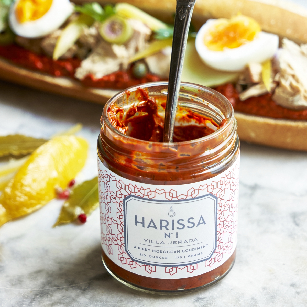open jar of Harissa Fiery with spoon resting inside