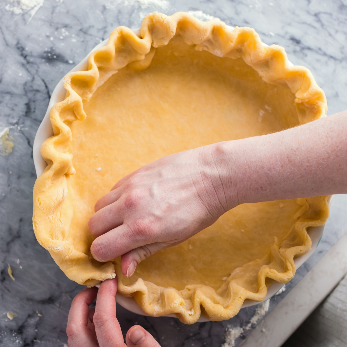 hands shaping pie dough 