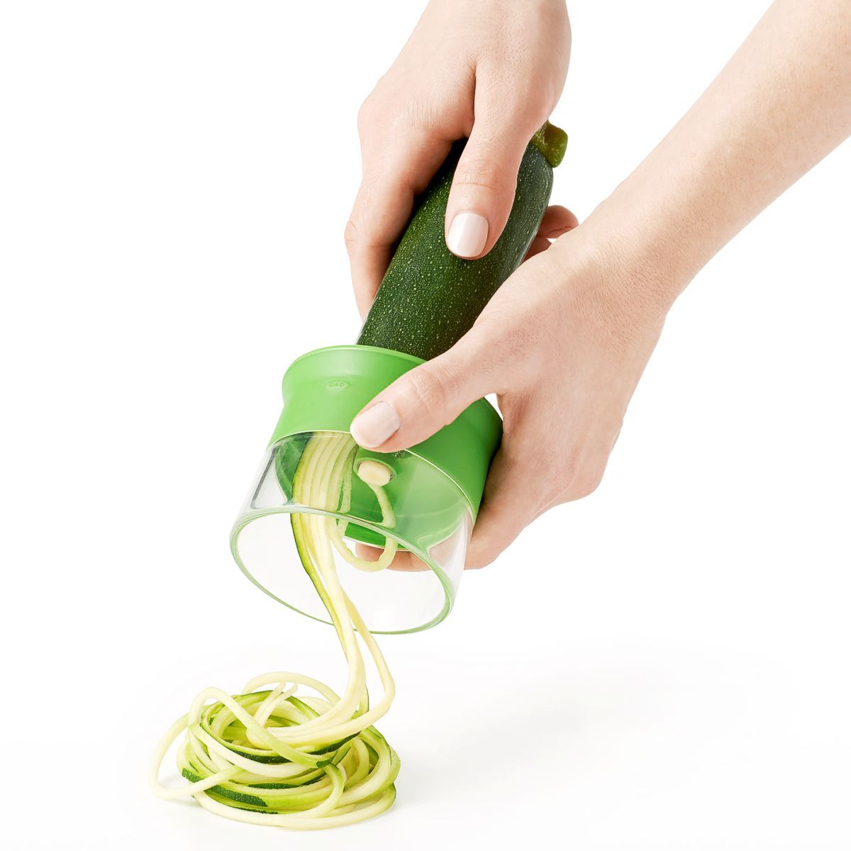 OXO Good Grips hand held spiralizer slicing a cucumber.