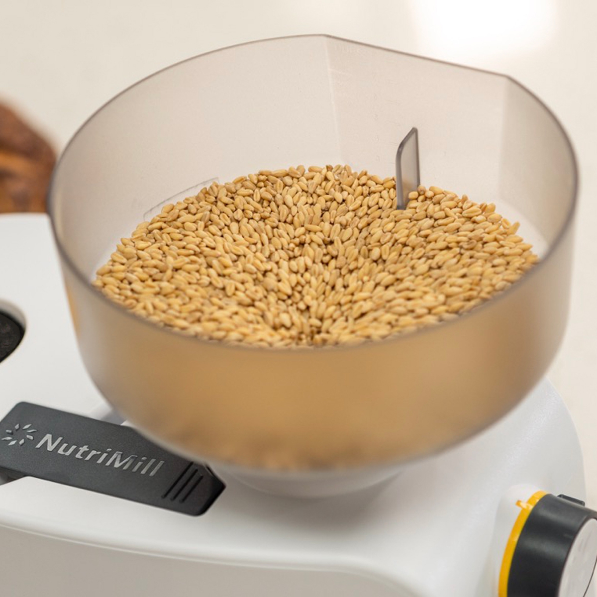 nutrimill impact grain mill hopper full of grain