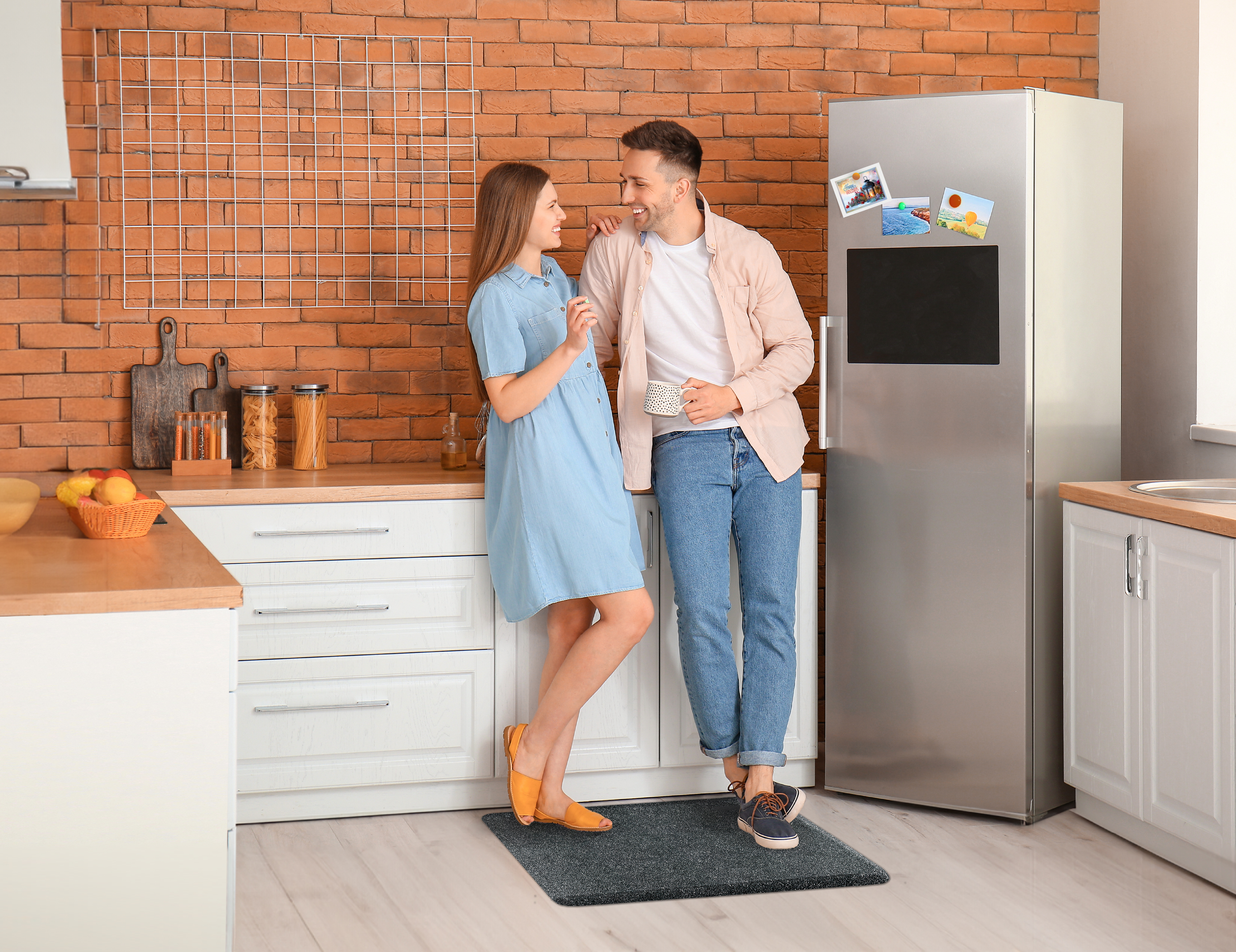 Granite Steel wellness mat shown in kitchen with man and women standing on it