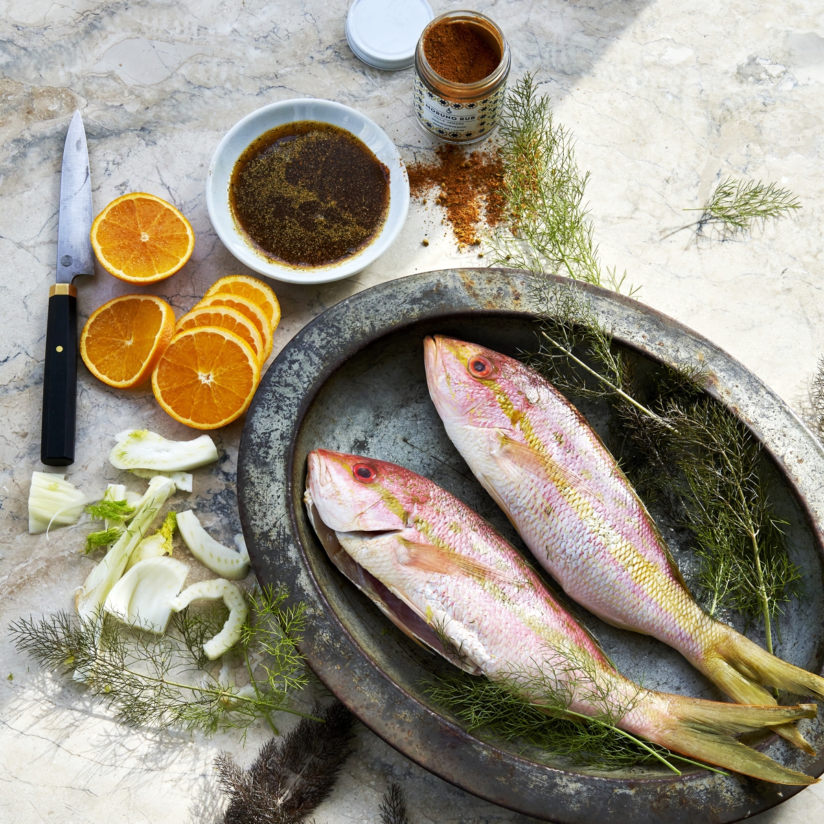 Moruna Rub sprinkled on fresh fish and garnished with oranges