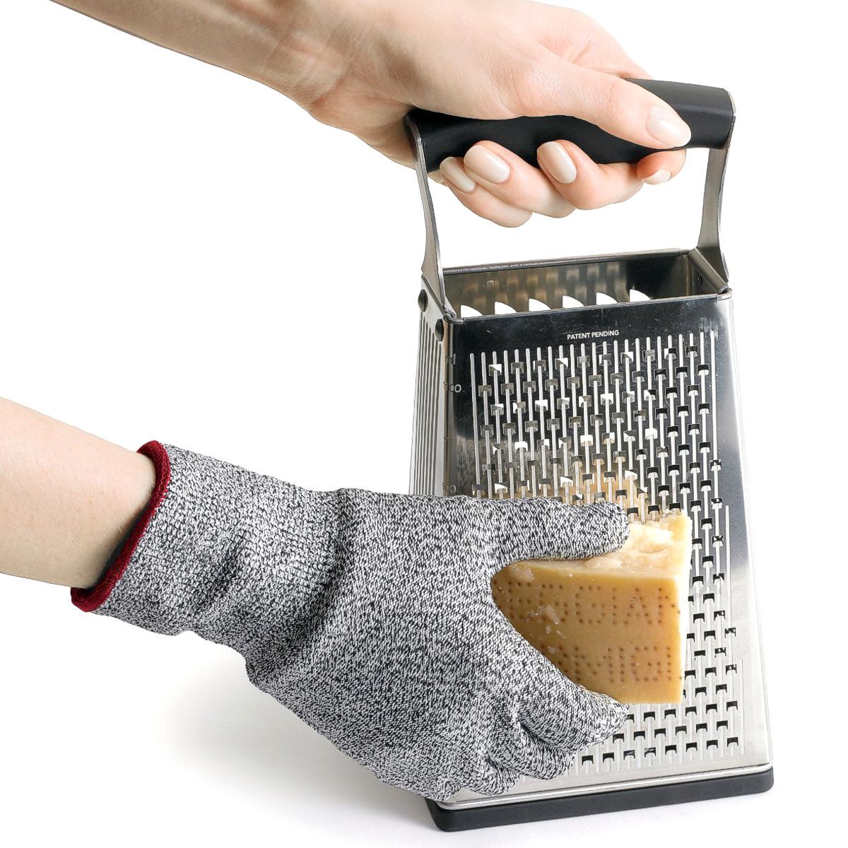 Grating cheese with gray Cuisipro cut resistant gloves. 