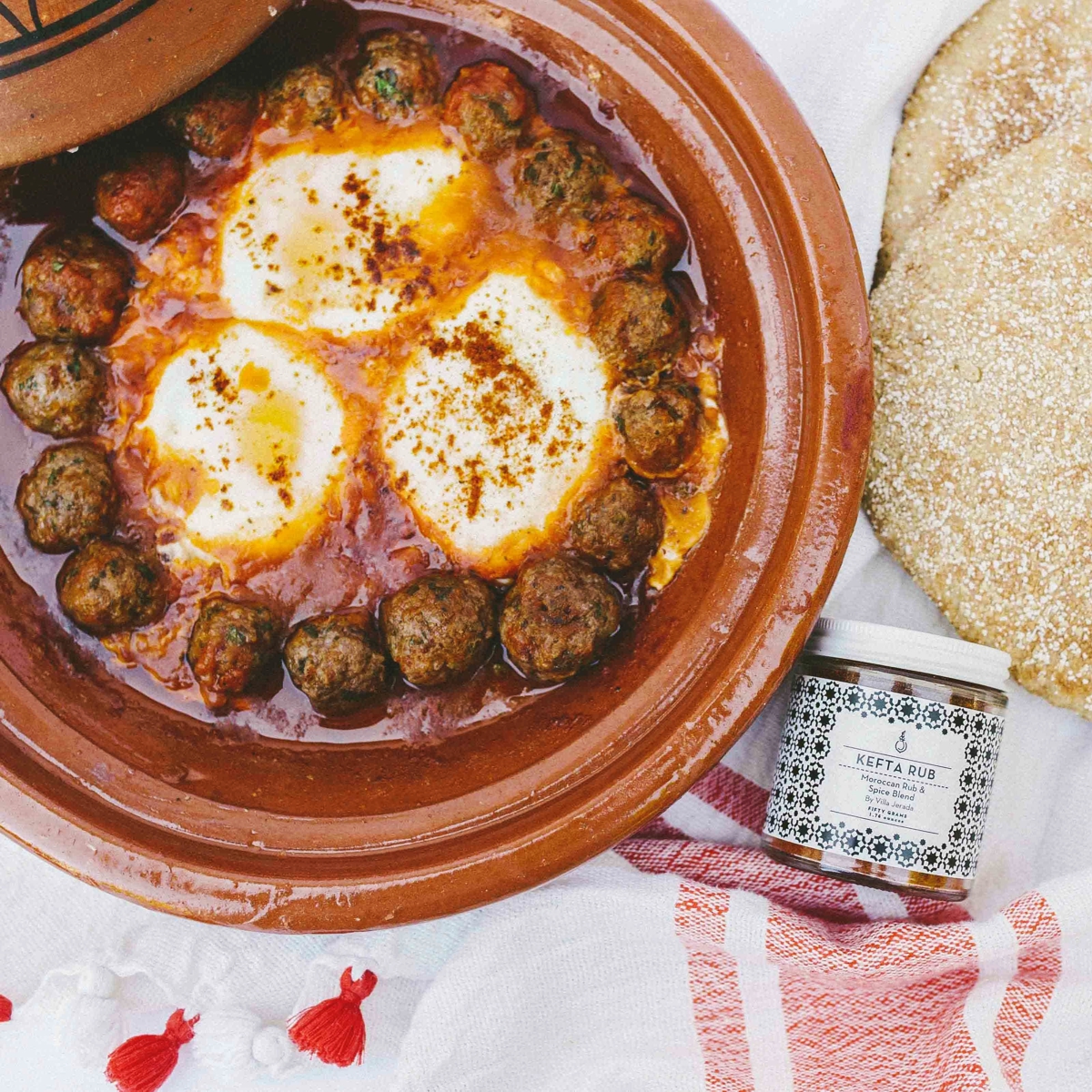 Jar of Kefta Rub Spice next to a plate of meatballs & eggs