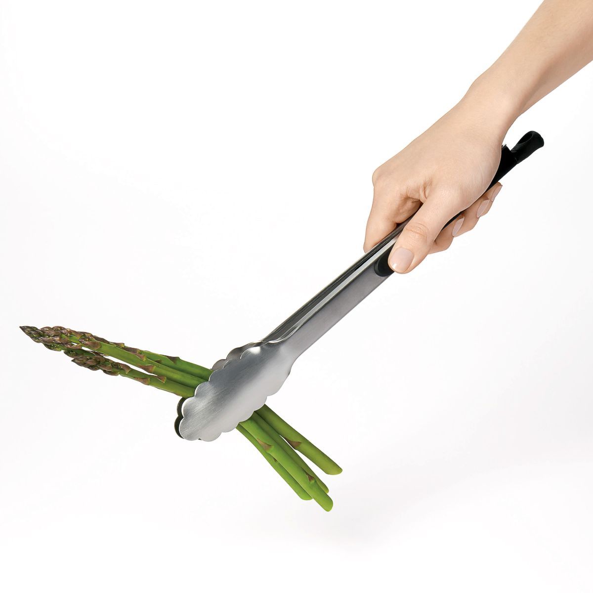 OXO Good Grips stainless steel locking tongs holding a bundle of asparagus.