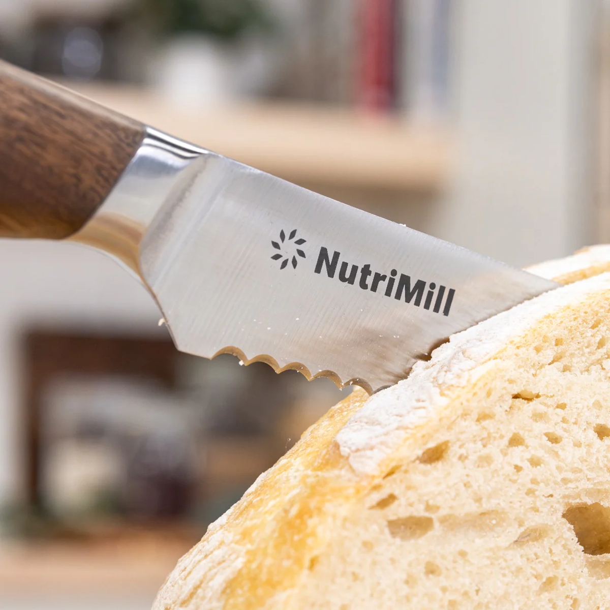 nutrimill bread knife cutting through loaf