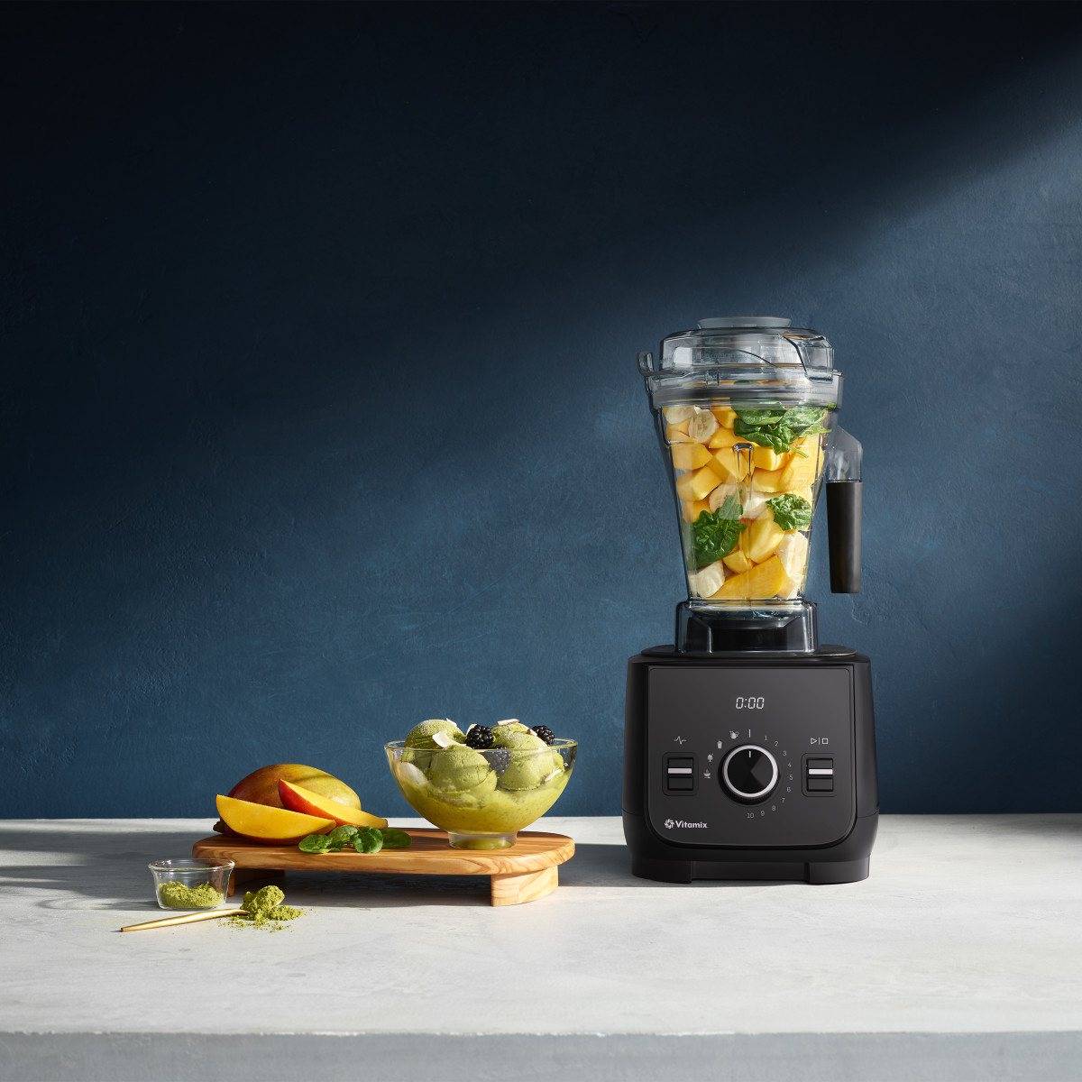 vitamix ascent x2 in frost white filled with fruit and vegetables