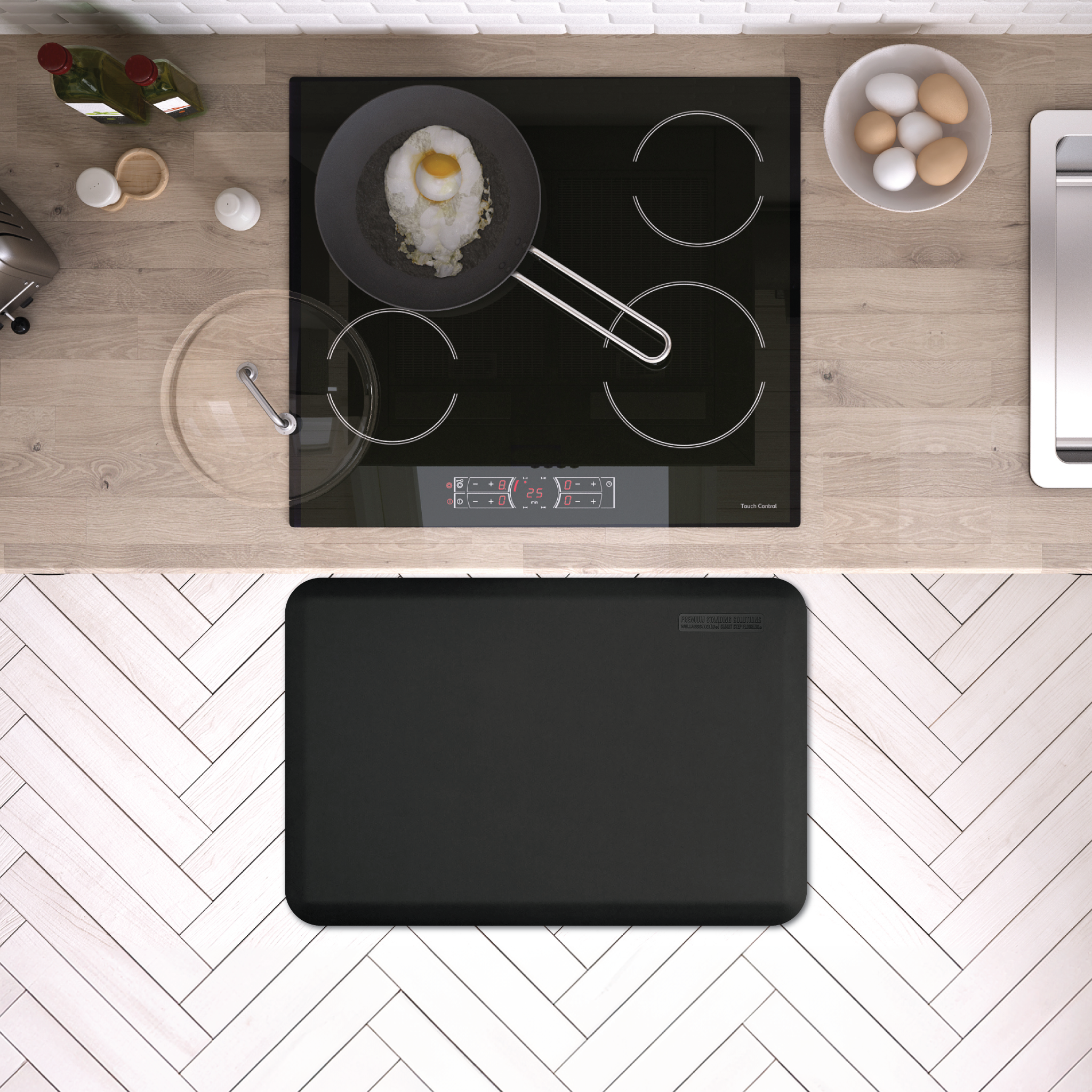 black wellness mat shown on white herringbone tile in front of stone range top