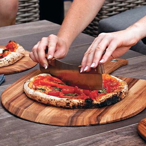 cutting pizza on acacia peel