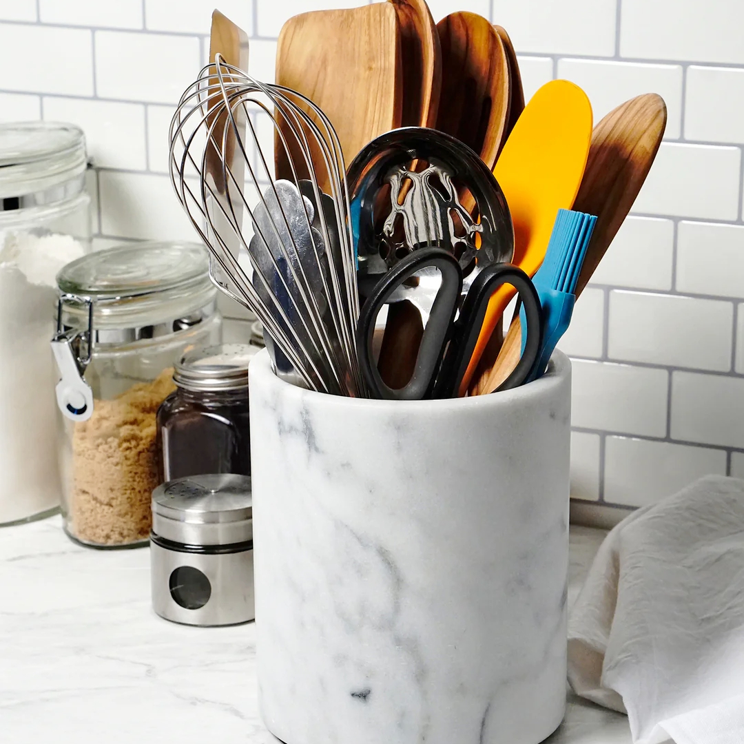 marble utensil crock with cooking utensils in it