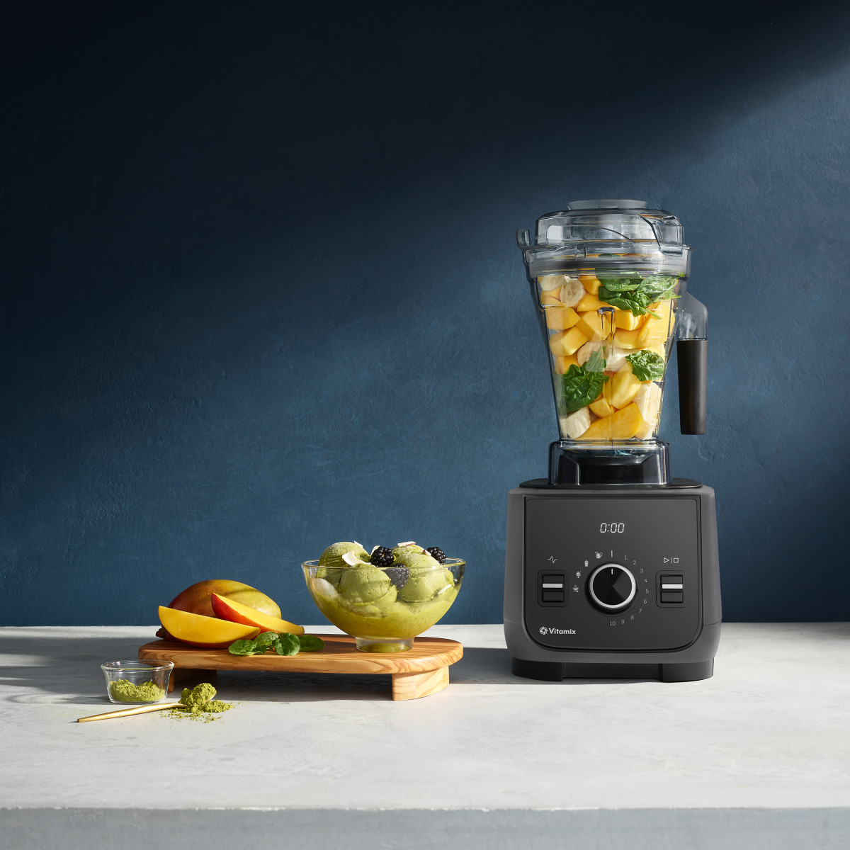 vitamix ascent x2 in frost white filled with fruit and vegetables