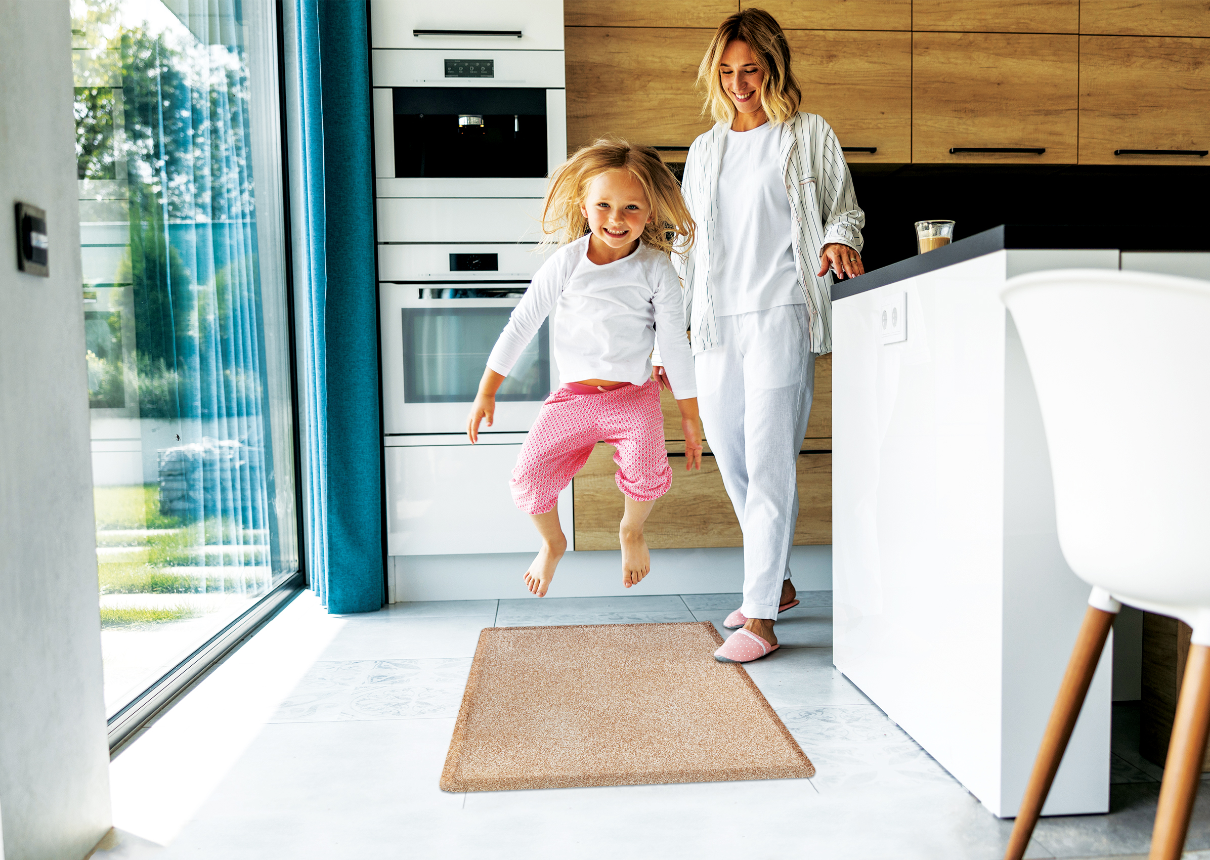 Granite Sand wellness mat in kitchen with little girl jumping on it