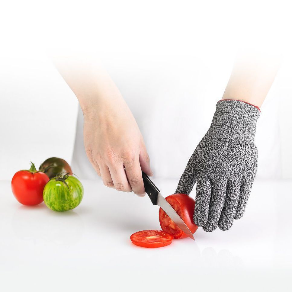 Gray Cuisipro cut resistant gloves in tomato cutting model.
