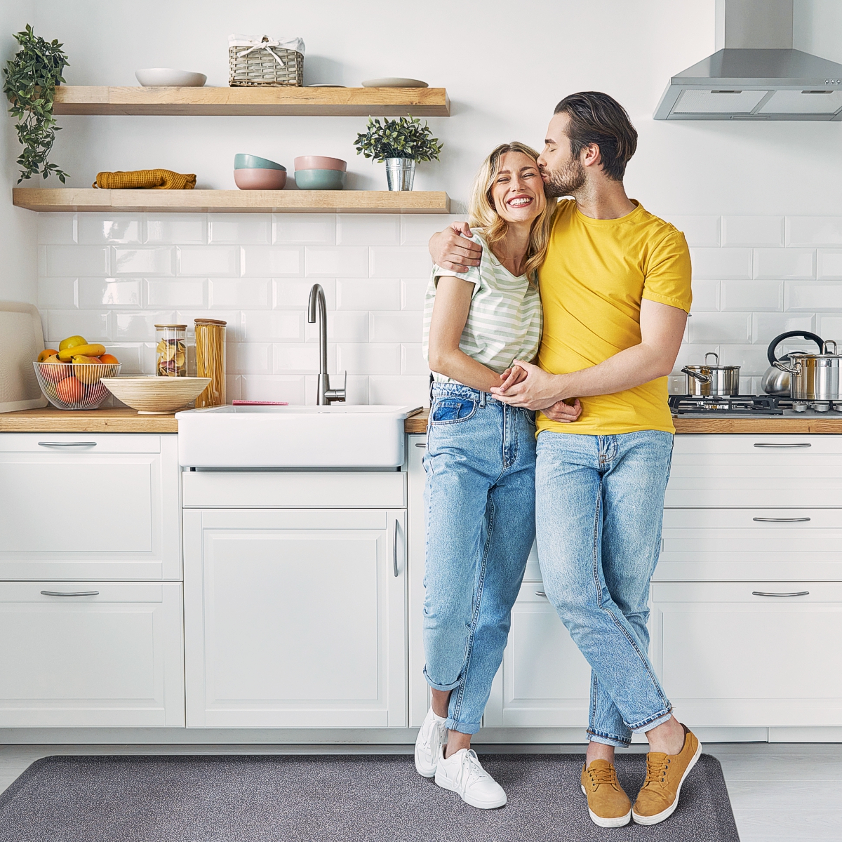 Granite wellness mat in kitchen with couple standing by sink