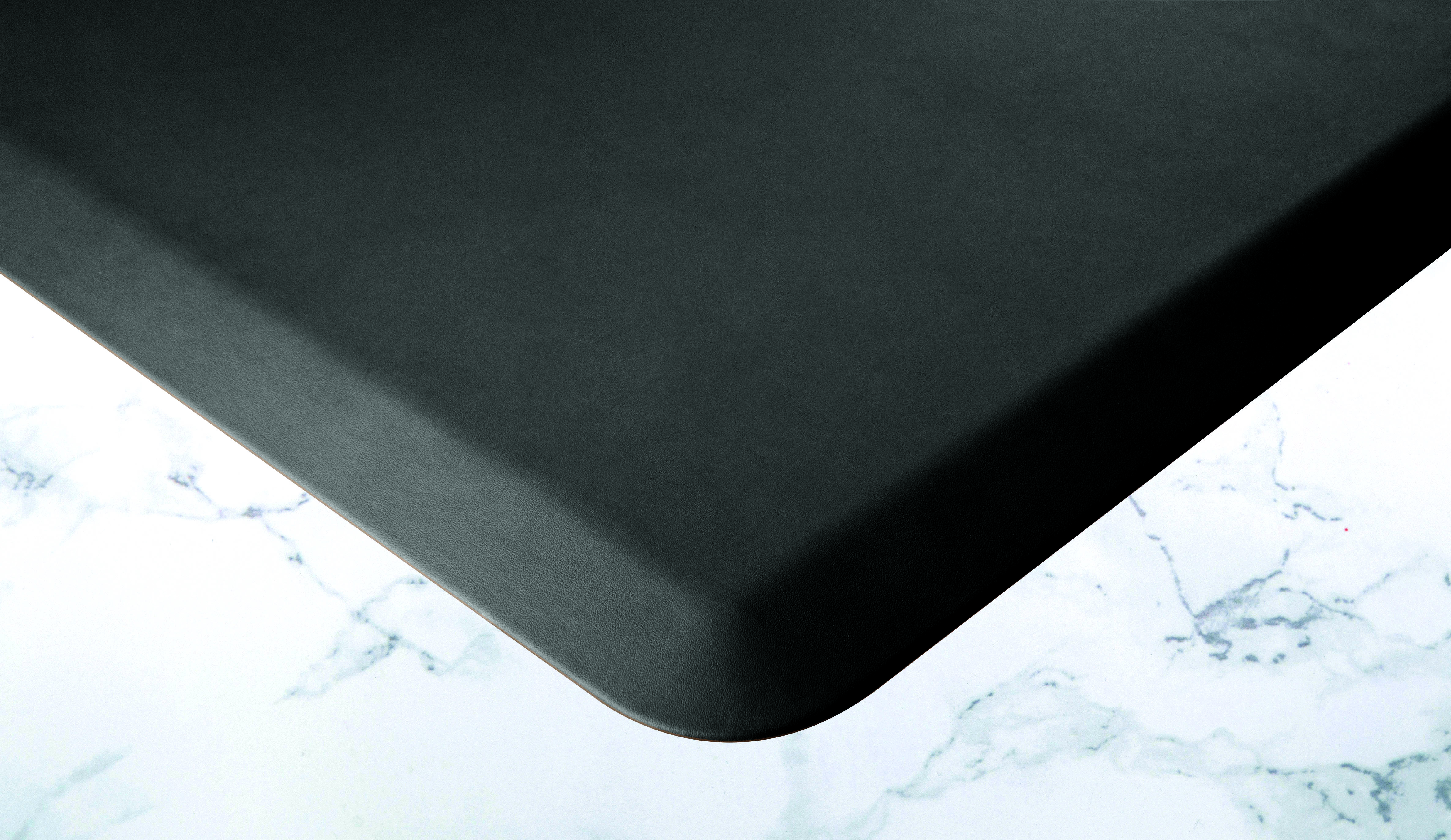 black wellness mat shown on white marble flooring