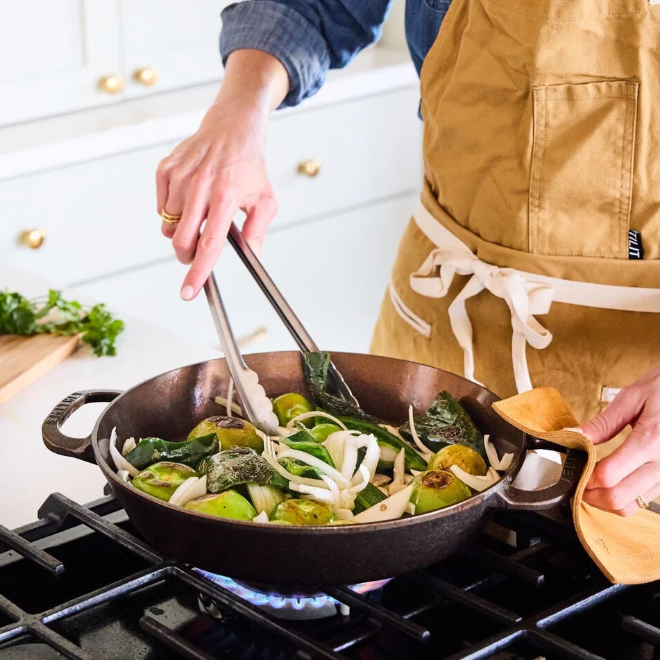 smithey dual skillet on stovetop preparing vegetables