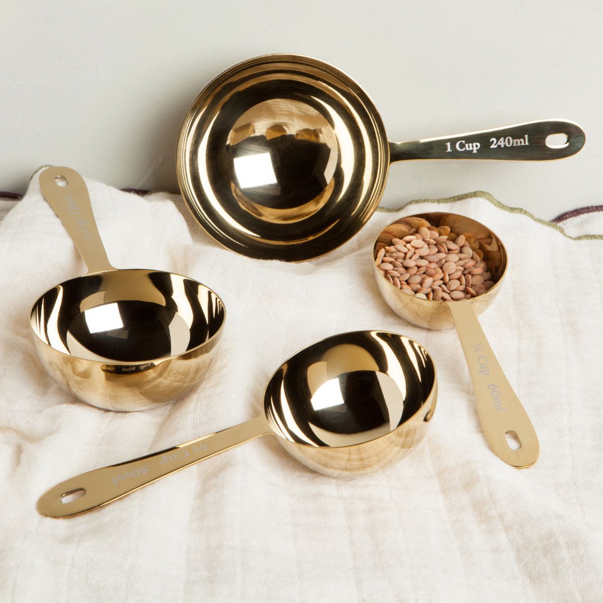 Stainless steel measuring cups with gold finish