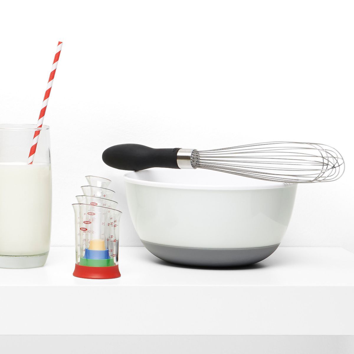 OXO Good Grips stainless steel whisk propped across mixing bowl.