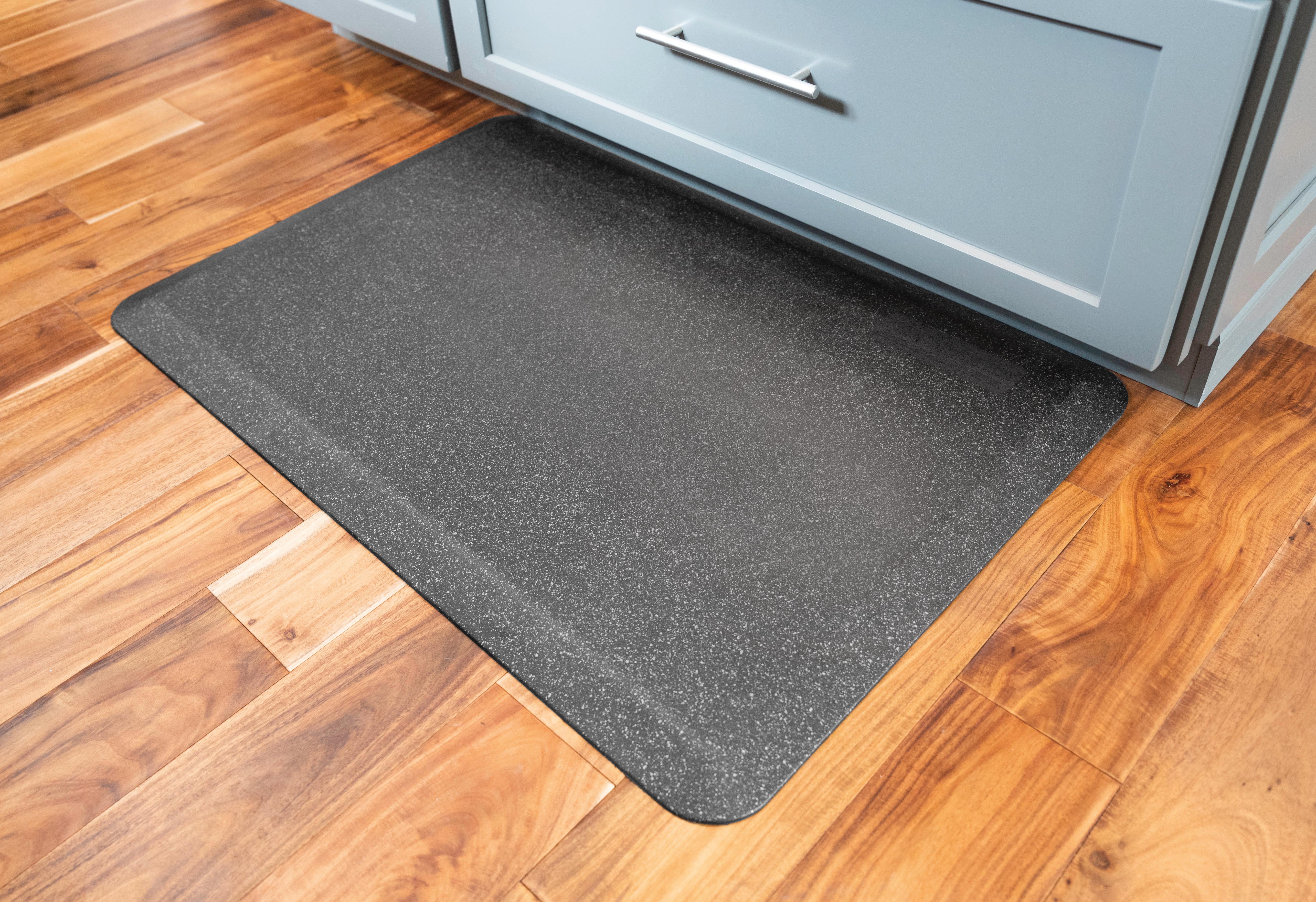 granite steel wellness mat in front of cabinet