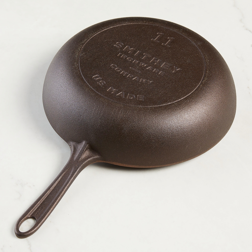 deep cast iron skillet with curved interior for easy movement