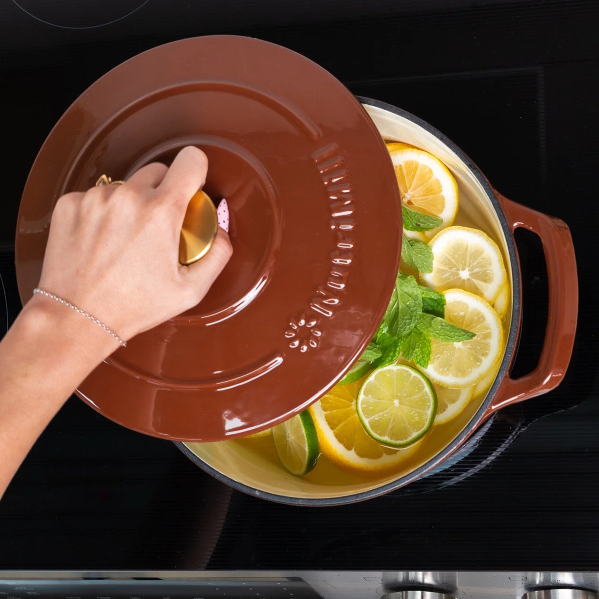nutrimill cast iron Dutch oven shown on stovetop with open lid