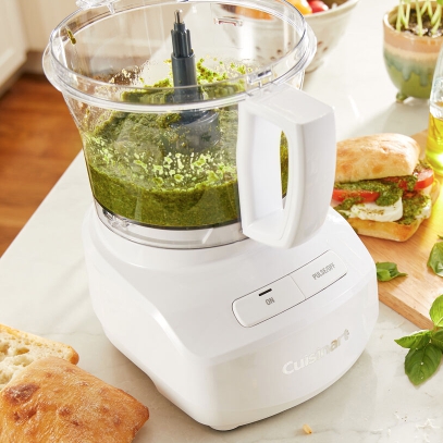 cuisinart white food processor on kitchen counter making pesto